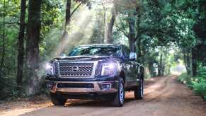 2019 Nissan Titan XD driving down dirt road