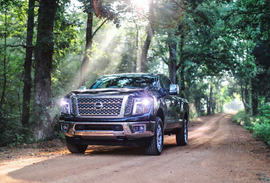 2019 Nissan Titan XD driving down dirt road