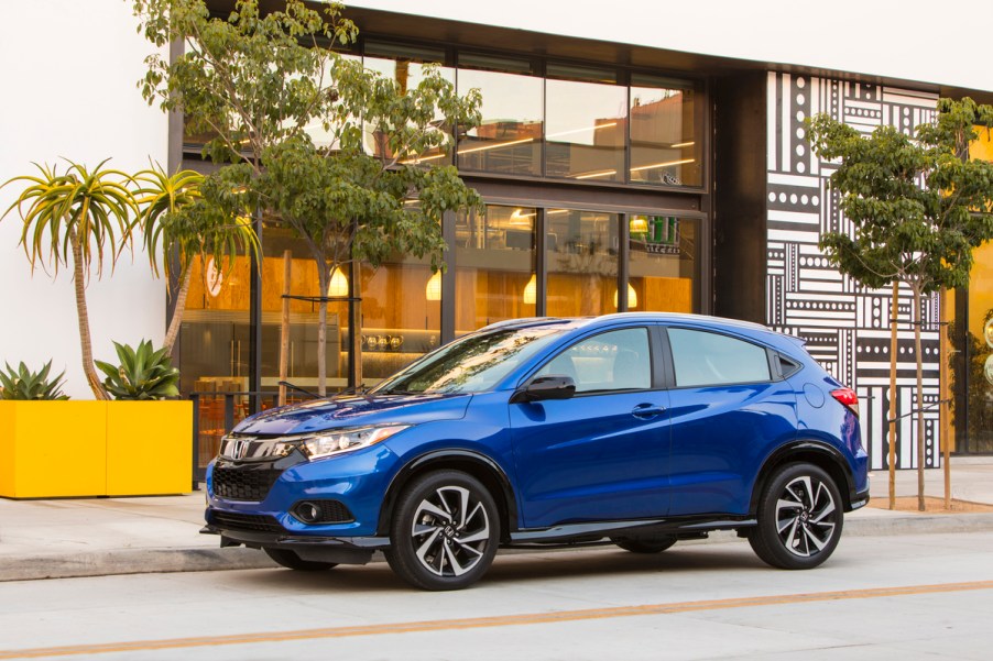 A blue 2019 Honda HR-V Sport parked outside a store front.