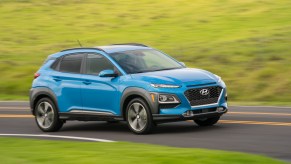 Hyundai Kona subcompact SUV driving on curvy country road