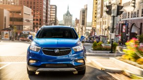 Electric Buick Encore driving through city streets.