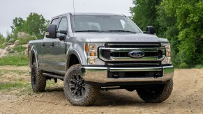 silver Super Duty Ford truck in the dirt