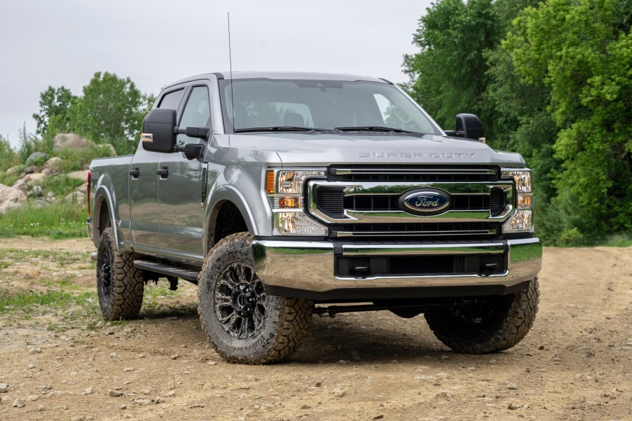 silver Super Duty Ford truck in the dirt