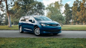 A blue Chrysler Voyager minivan parked on street