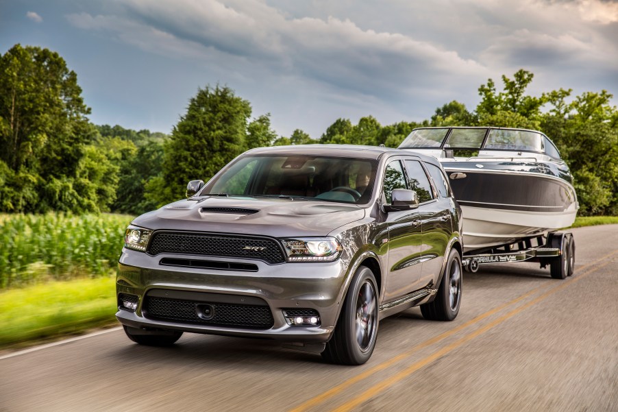 2019 Dodge Durango SRT towing a boat down a country road