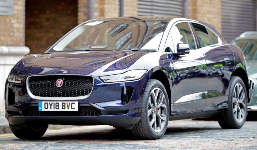 A grey Jaguar I-Pace parked on a city street.