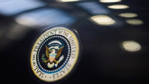 A replica of the JFK car, a Lincoln Continental, shows off its presidential seal.