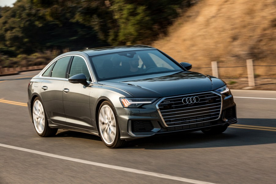 A grey Audi A6 sedan driving down the countryside.