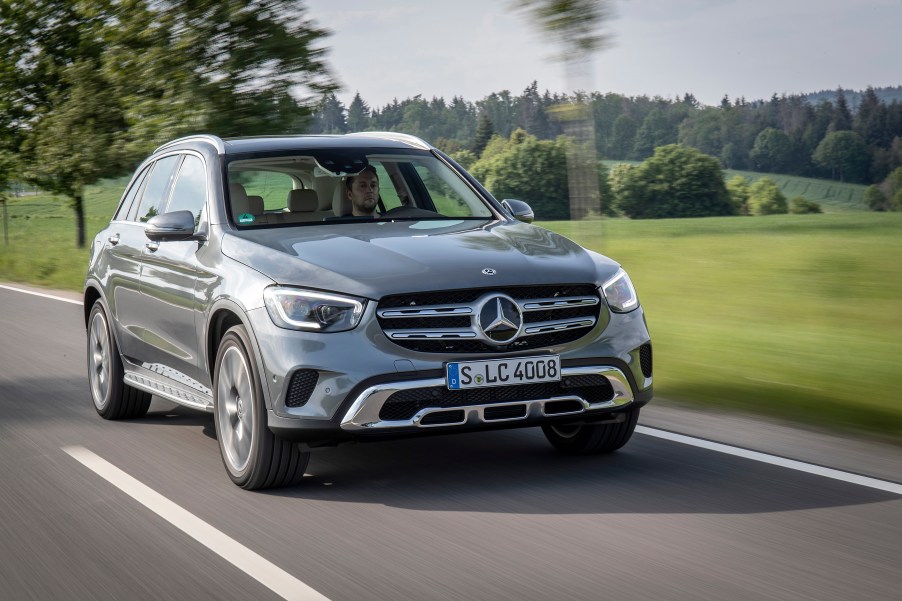 A chrome Mercedes-Benz GLC SUV driving down the road.