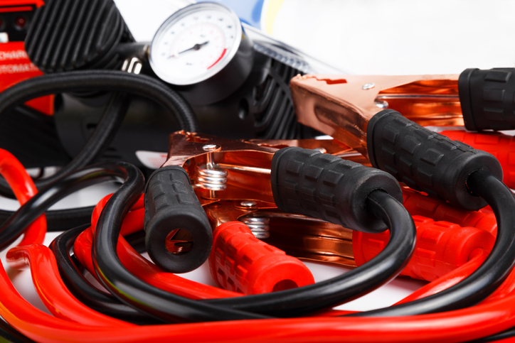 Emergency jumper cabls and a tire pressure gauge.