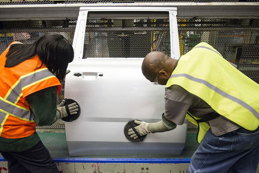 auto workers buffing car door