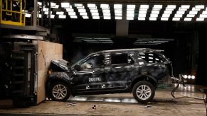 A Ford SUV slams into a wall during a crash rating test.