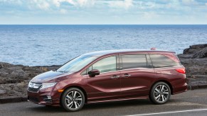 burgundy 2020 Honda Odyssey driving along a shoreside roadway