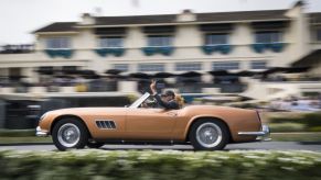 A 1960 Ferrari 250 GT Scaglietti Spyder California is driven onto the winners ramp during the 2019 Pebble Beach Concours d'Elegance in Pebble Beach, California