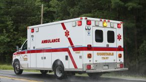 An ambulance driving down a road.