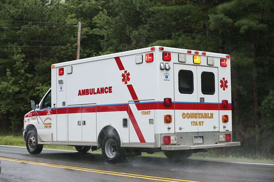 An ambulance driving down a road.