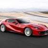 A red Ferrari 812 Superfast taking a turn at a racetrack