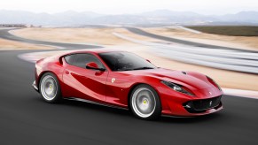 A red Ferrari 812 Superfast taking a turn at a racetrack