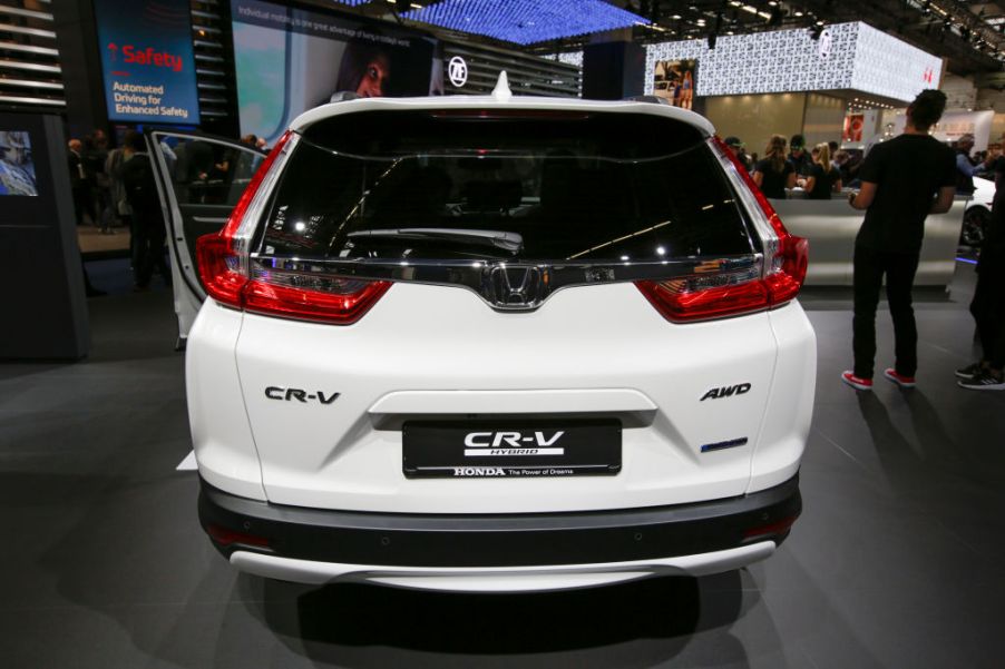 A white Hybrid Honda CR-V viewed from the back.