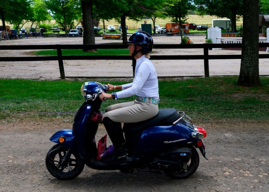 Woman riding on a moped.