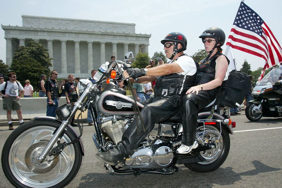 Two members of a motorcycle club taking part in a rally.