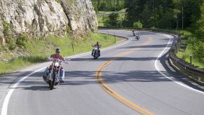 Motorcycles driving down a curved road