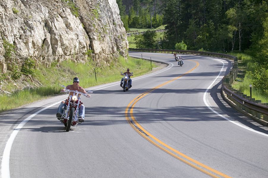 Motorcycles driving down a curved road