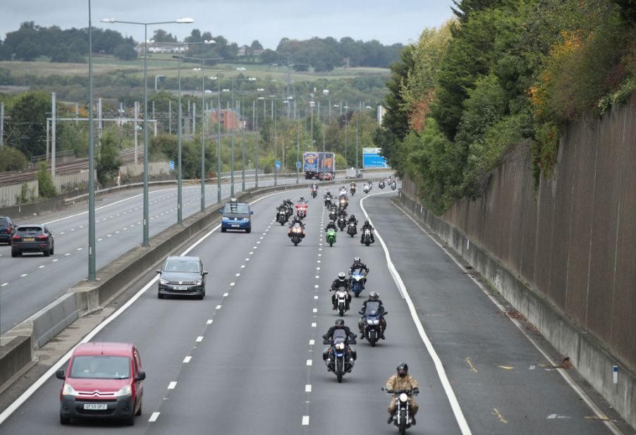 Motorcycles drive along the M1 motorway toward central London