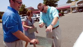 A couple participates in a Craigslist car sales transaction