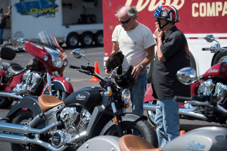 A salesman talks with a customer after a test drive on the new Indian Scout motorcycle