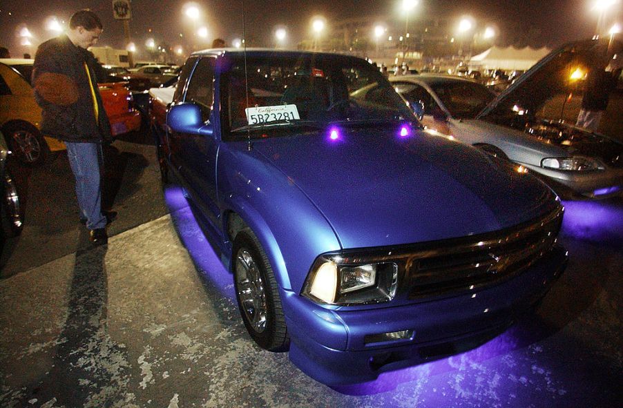 Man stands next to his modified 1995 Chevy S10