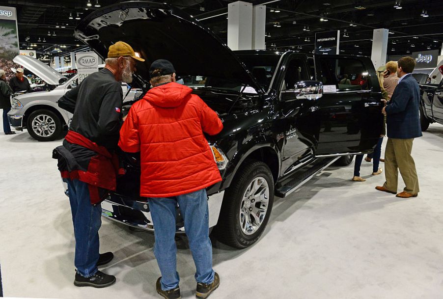 People look at the 2015 Black Dodge Ram 1500