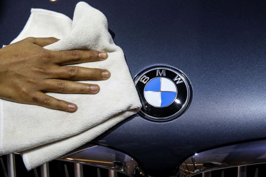 The hood of a BMW being cleaned off by a towel