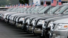 A row of trucks for sale at a dealership.