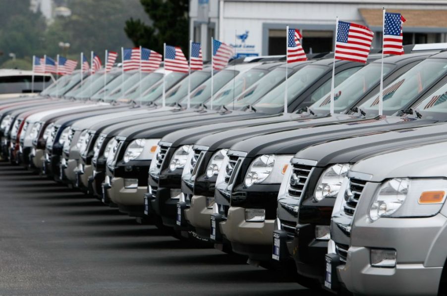 A row of trucks for sale at a dealership.