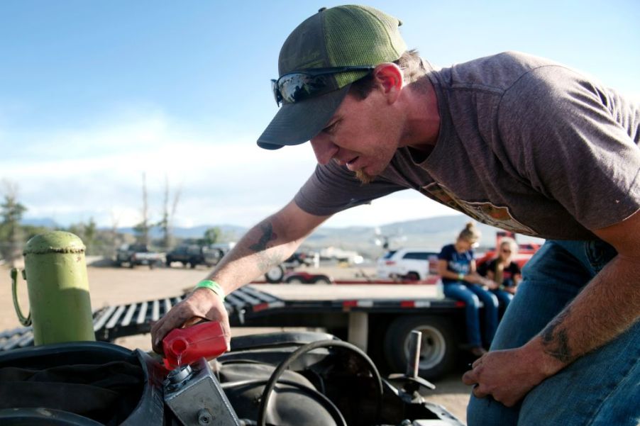 Man tops off power steering fluid