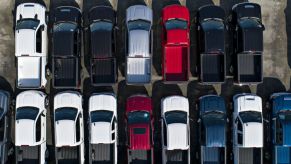 Chevrolet Silverado trucks are displayed at a car dealership