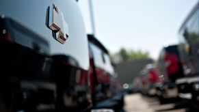 A car dealership lot with a row of Chevy trucks for sale.