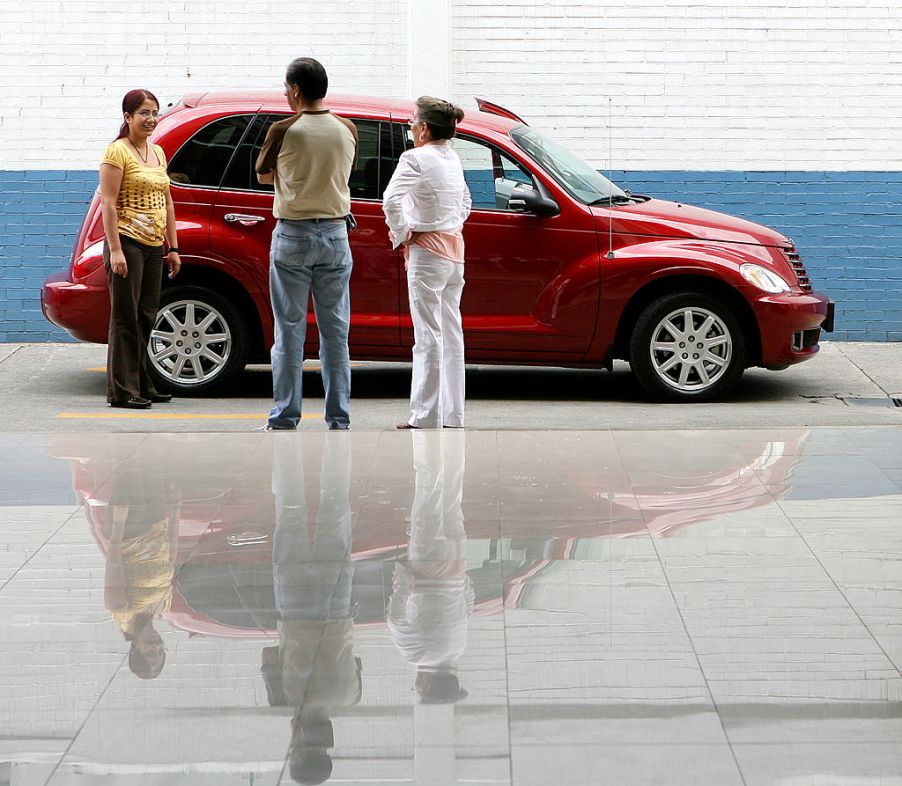 Customers look over a Chrysler PT Cruiser