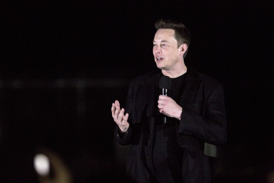 Tesla CEO Elon Musk gives a presentation on stage.