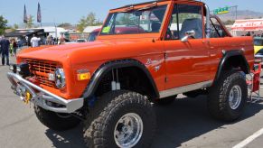 An orange Ford Bronco in a parking lot.