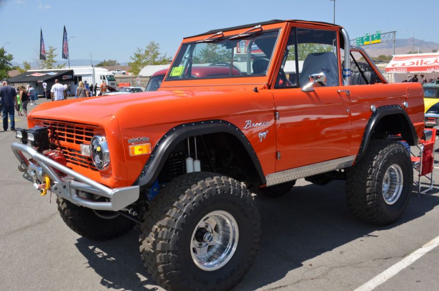 An orange Ford Bronco in a parking lot.