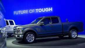 A blue Ford F-Series truck on display at an auto show.