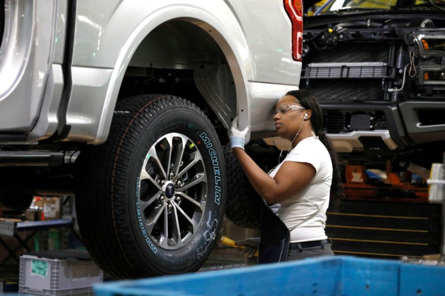 A Ford Motor Company worker works on a Ford F-150 truck on the assembly line at the automaker's Dearborn Truck Plant