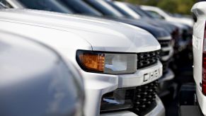 GM Chevrolet Silverado trucks are displayed at a car dealership