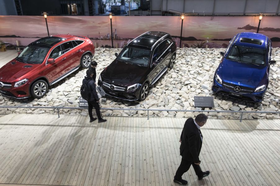 The Mercedes-Benz GLE Coupe, GLC L SUV, and GLC Coupe sit on display at an event ahead of the Shanghai Auto Show