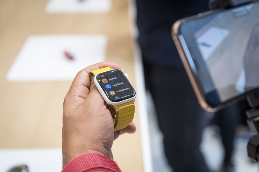 Person holding a Series 5 Apple Watch