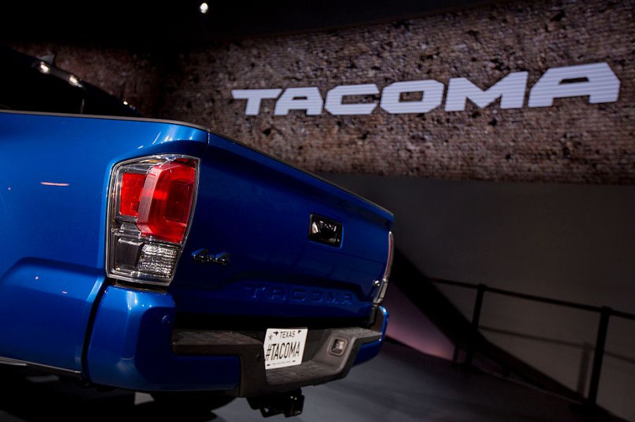 A 2016 Toyota Tacoma with it's tailgate on display at an auto show.