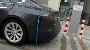 A Tesla Model S electric car parked at a charging station.