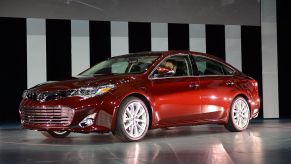 A red Toyota Avalon on display at an auto show.